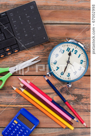 School homework accessories on a brown wooden table. School homework accessories on a brown wooden table. 67002998