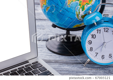 Laptop with globalization and time concept. 67003121