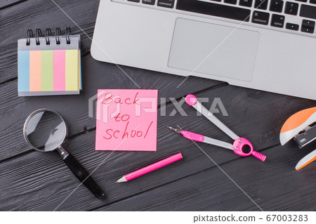 Stationary clerical items on the dark wooden table. Stationary clerical items on the dark wooden table. 67003283