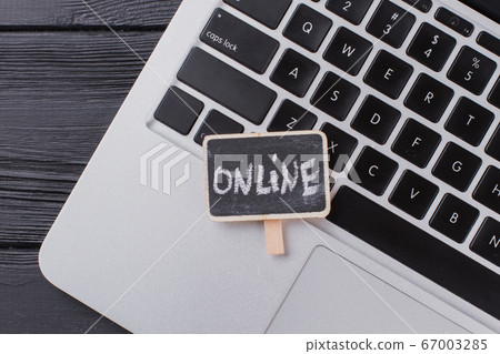 Close up laptop keyboard and online word. Close up laptop keyboard and online word. 67003285