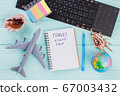 Flat lay composition with airplane, globe, seashells and notepad on blue desk. 67003432