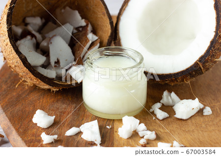 Coconut oil and fresh coconuts on the table Coconut oil and fresh coconuts on the table 67003584