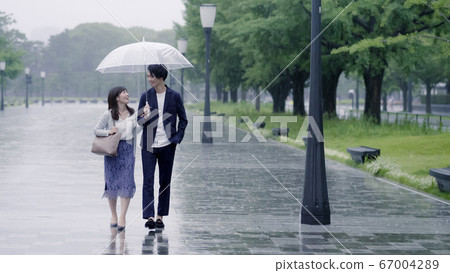 情侶約會在雨天用一把雨傘 情侶約會在雨天用一把雨傘 67004289