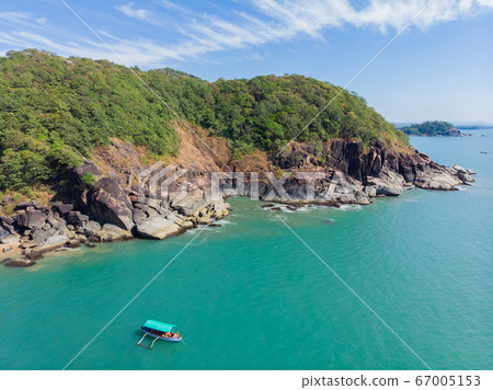 Beautiful secret beach Butterfly in Goa, India. Aerial view of pristine beach with rocky bay and waves crashing. Beautiful secret beach Butterfly in Goa, India. Aerial view of pristine beach with rocky bay and waves crashing. 67005153