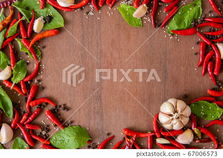 Red peppers and holy basil black pepper seeds, garlic on the wood floor,Free space Enter text and images. Red peppers and holy basil black pepper seeds, garlic on the wood floor,Free space Enter text and images. 67006573