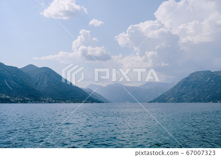 Kotor Bay in Montenegro. Sea water at the foot of the mountains. Kotor Bay in Montenegro. Sea water at the foot of the mountains. 67007323