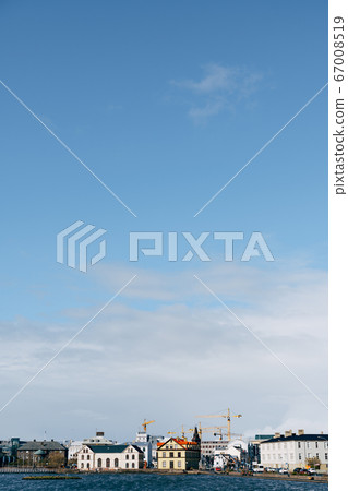 Buildings on the shore of Lake Tjodnin, in Reykjavik, the capital of Iceland. 67008519