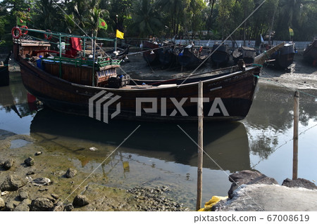 Cox's Bazar in Bangladesh Coastal fishing village and fishing boats on a traditional traditional hull and Bangladesh flag 67008619