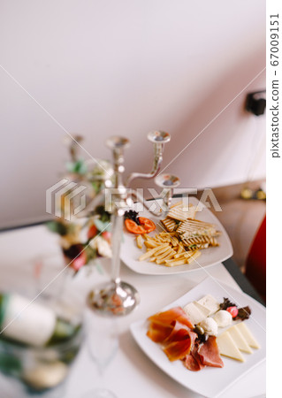 Breakfast plates on the table - cheese and meat slicing, toast and fries. Breakfast plates on the table - cheese and meat slicing, toast and fries. 67009151