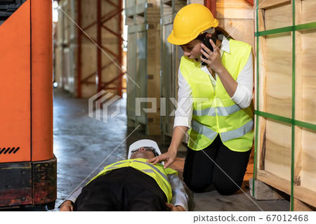 Warehouse worker call ambulance after accident 67012468