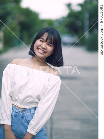 toothy smiling face of asian teenager standing toothy smiling face of asian teenager standing 67013093