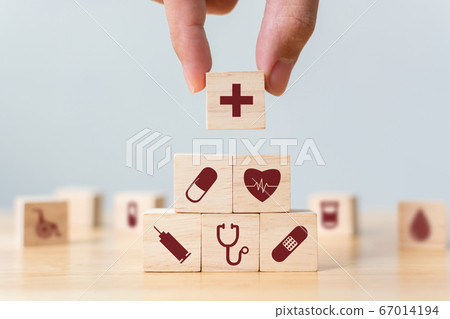 Hand arranging wood block stacking with icon healthcare medical, Insurance for your health concept 67014194