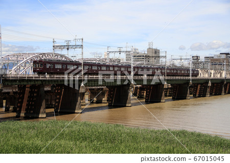 Hankyu Kyoto Main Line 5300 series train crossing the Yodo River Bridge after the typhoon 67015045