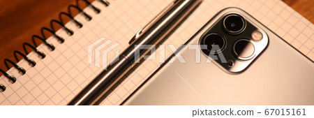 Apple iphone pro on notebook keyboard Apple iphone pro on notebook keyboard 67015161