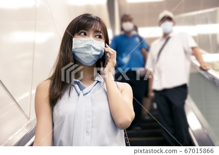business woman wearing face mask at train station business woman wearing face mask at train station 67015866