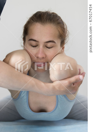 Young woman having osteopathy treatment - lying in the pose with her elbows forward Young woman having osteopathy treatment - lying in the pose with her elbows forward 67017454