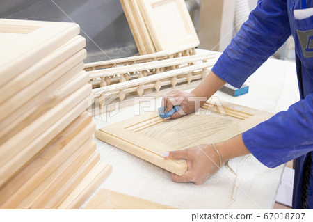 diligent female carpenter sanding wood at the workshop diligent female carpenter sanding wood at the workshop 67018707