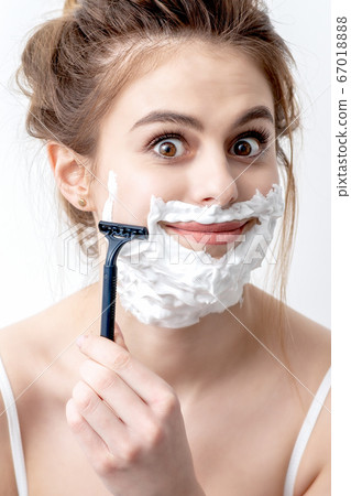 woman shaving her face