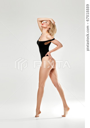 young blonde woman in black bodysuit 67018889