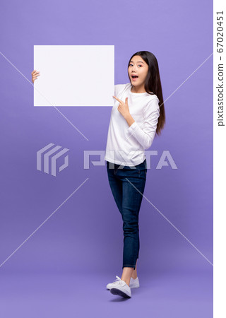 Smiling cheerful Asian woman pointing hand to blank paper board Smiling cheerful Asian woman pointing hand to blank paper board 67020451