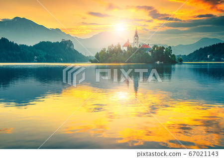 Pilgrimage church with island and lake Bled at sunrise, Slovenia Pilgrimage church with island and lake Bled at sunrise, Slovenia 67021143