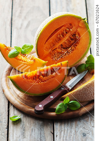 Sweet fresh melon on the wooden table Sweet fresh melon on the wooden table 67021624