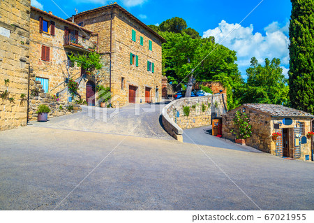 Tuscany street and rustic stone houses decorated with flowers, Monticchiello Tuscany street and rustic stone houses decorated with flowers, Monticchiello 67021955
