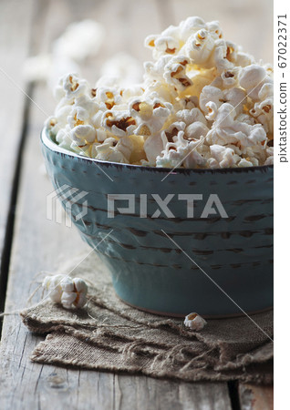 Popcorn and cola on the wooden table Popcorn and cola on the wooden table 67022371