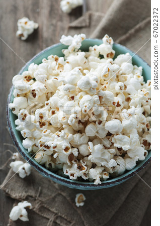 Popcorn and cola on the wooden table Popcorn and cola on the wooden table 67022372