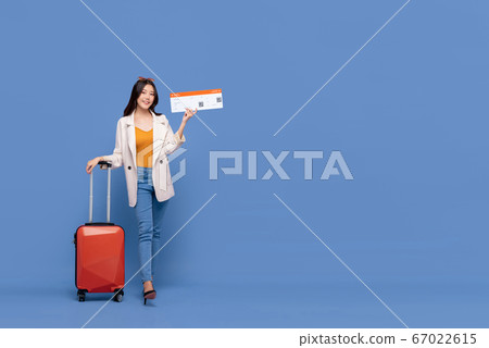Asian woman tourist with baggage showing boarding pass ready for traveling  67022615