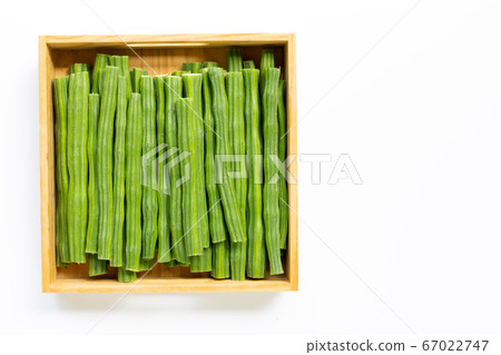 Moringa oleifera in wooden box isolated on white Moringa oleifera in wooden box isolated on white 67022747