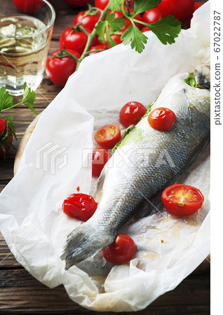 Cooked seabass with tomato and parsley Cooked seabass with tomato and parsley 67022787