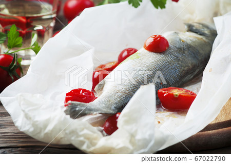 Cooked seabass with tomato and parsley Cooked seabass with tomato and parsley 67022790