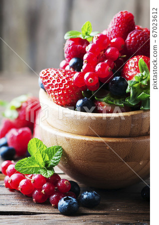 Mix of berry on the wooden table 67023612