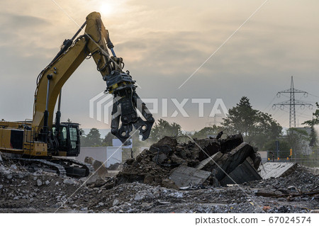 Building House Demolition site Excavator with hydraulic crasher machine and yellow container 67024574