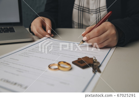 Woman signing marriage contract, closeup Woman signing marriage contract, closeup 67025291