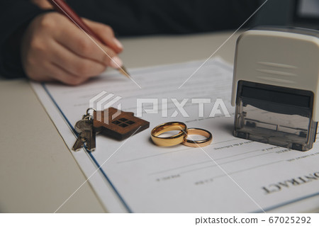 Woman signing marriage contract, closeup Woman signing marriage contract, closeup 67025292
