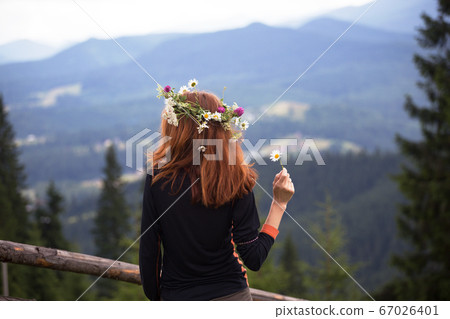 girl in a wreath of wildflowers 67026401