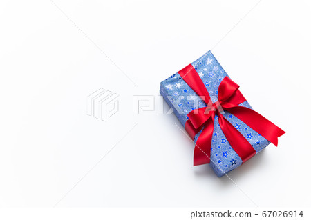 Blue gift box with red ribbons isolated on white 67026914