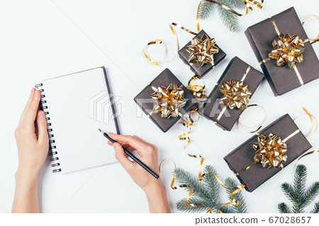Top view female hands writing Christmas list Top view female hands writing Christmas list 67028657