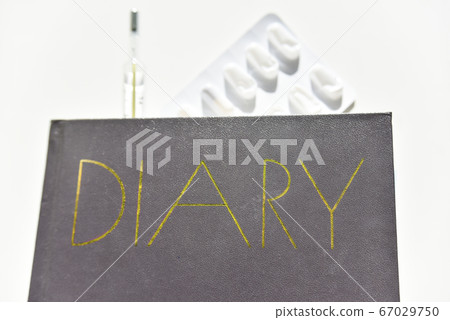 selective focus of the diary with thermometer and selective focus of the diary with thermometer and 67029750