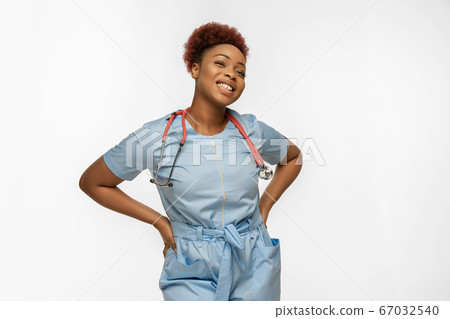 Beautiful african-american doctor or nurse smiling isolated over white studio background 67032540