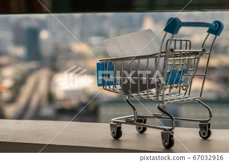 A credit card in a Mini supermarket trolley. A credit card in a Mini supermarket trolley. 67032916