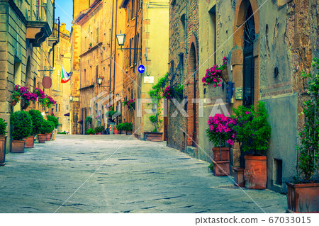 Brick and stone houses decorated with colorful flowers, Pienza, Italy Brick and stone houses decorated with colorful flowers, Pienza, Italy 67033015