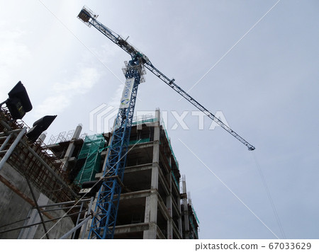 Tower Crane used to lift the heavy load at the construction site. Manually operate by the operator. Normally used at huge scale or high rise building construction.    67033629