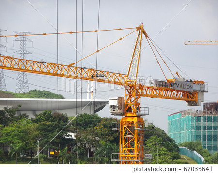 Tower Crane used to lift the heavy load at the construction site. Manually operate by the operator. Normally used at huge scale or high rise building construction.    67033641