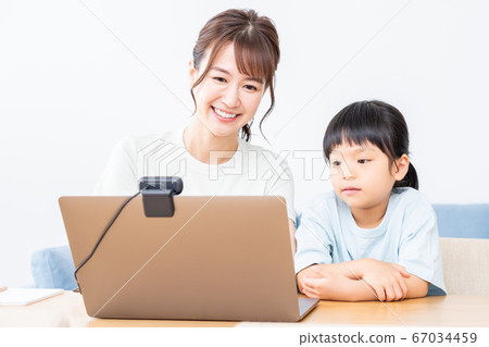 Parents and children enjoying an online seminar on a laptop Parents and children enjoying an online seminar on a laptop 67034459