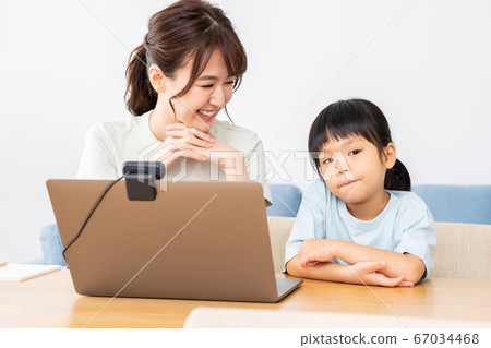 Parents and children enjoying an online seminar on a laptop Parents and children enjoying an online seminar on a laptop 67034468