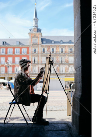 Old Male Street Painter Drawing Portrait Of Tourist Old Male Street Painter Drawing Portrait Of Tourist 67034525