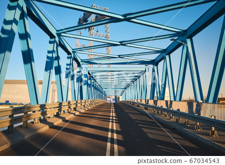 Modern road bridge in industrial area at sunset. Modern road bridge in industrial area at sunset. 67034543